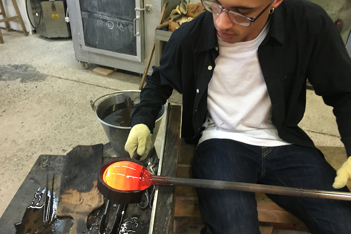 glassblowing experience, glass course student working hot glass