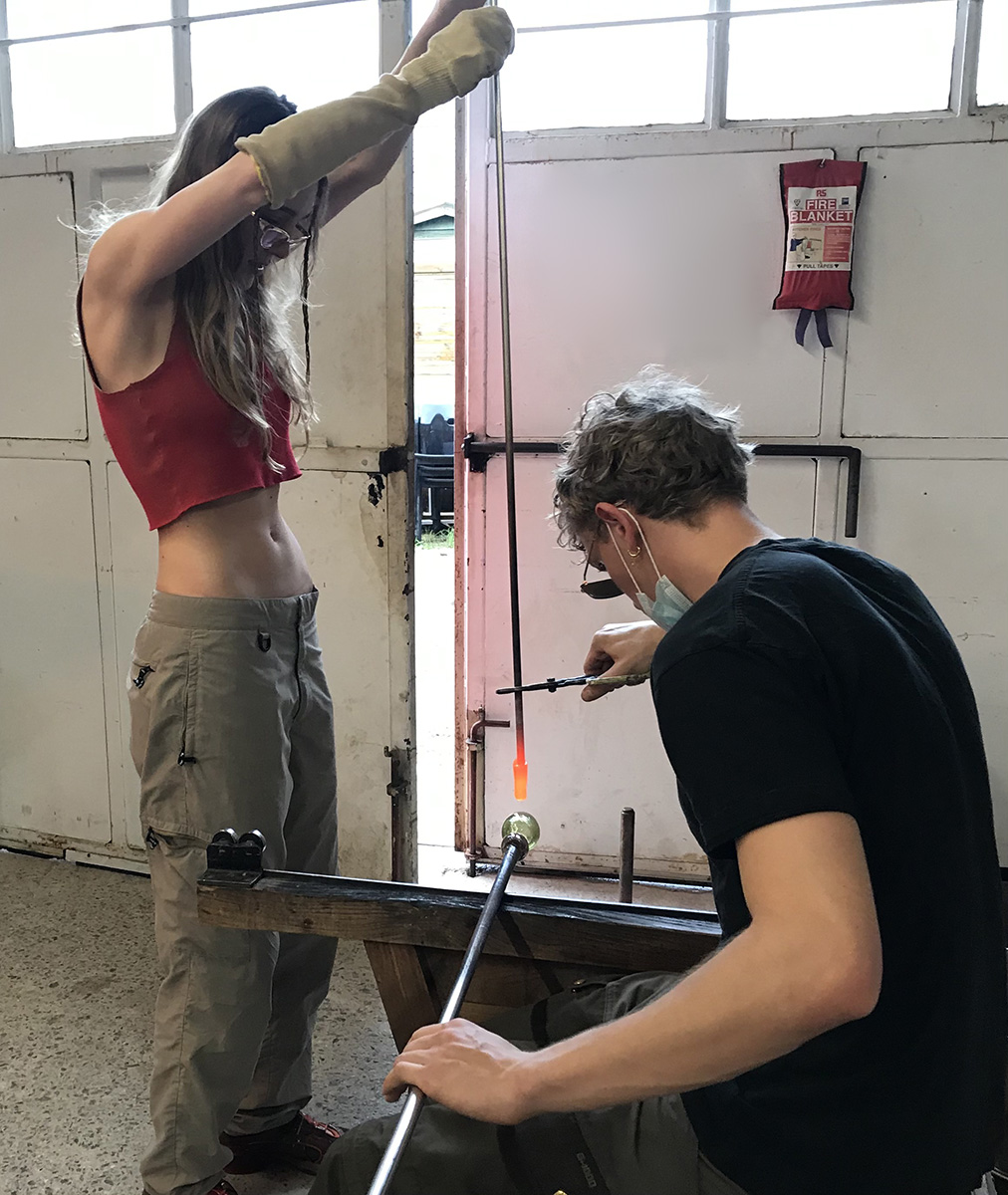 Breanna Box and Peter Dupont working together with hot glass