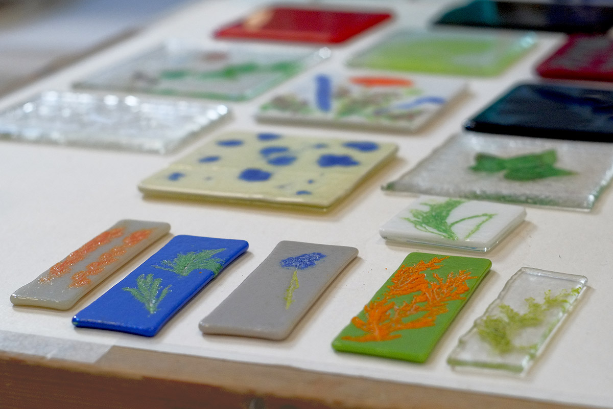 Fused glass including reactive glass and fossil vitra